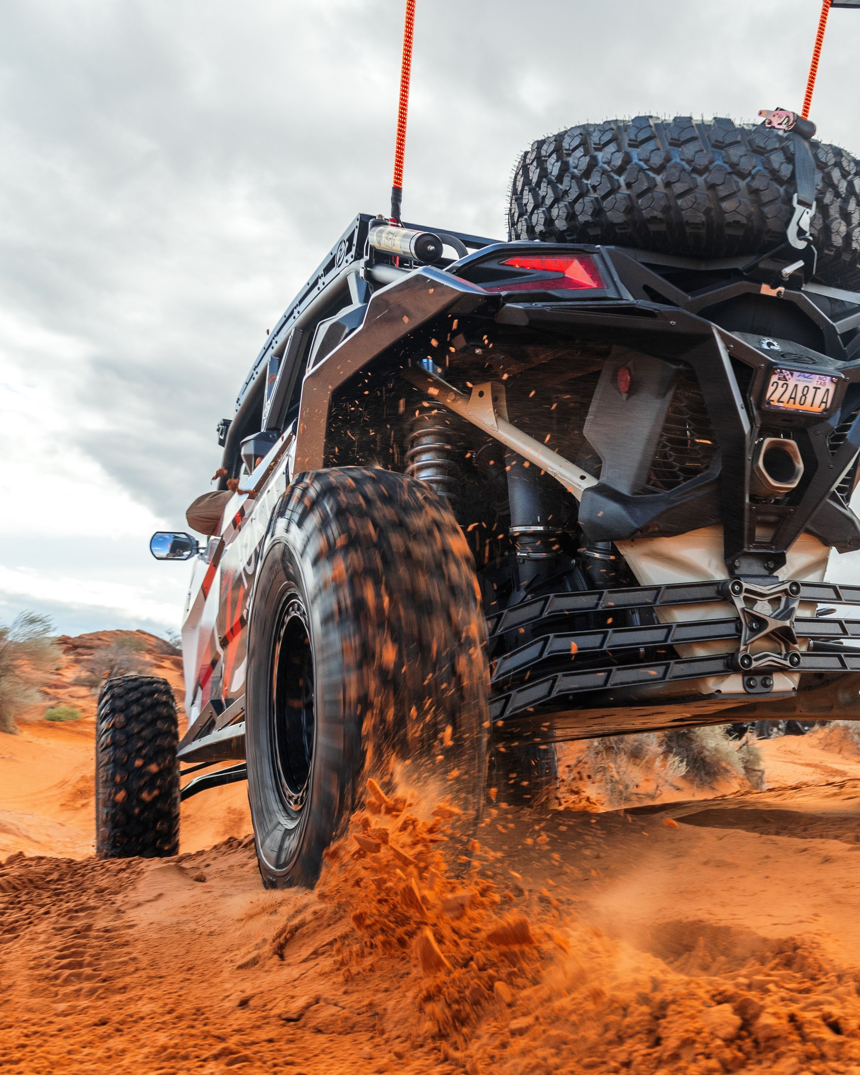 2017 to Current Can-Am X3 Maverick High Clearance Radius Rods in Black Finish for 72" on a UTV in a sandy off-road landscape.