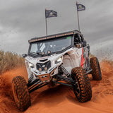 2017 to Current Can-Am X3 Maverick Machined Billet Front Winch Bumper (Clear Anodize) in action on sandy terrain.