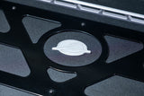 Close-up of the emblem on the 2017-2024 Can Am X3 Maverick Volt Series Baja Bed Box, showcasing quality craftsmanship.