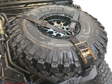 2017-2024 Can Am X3 Maverick Volt Series Baja Spare Tire Rack with mounted tire and secure straps.