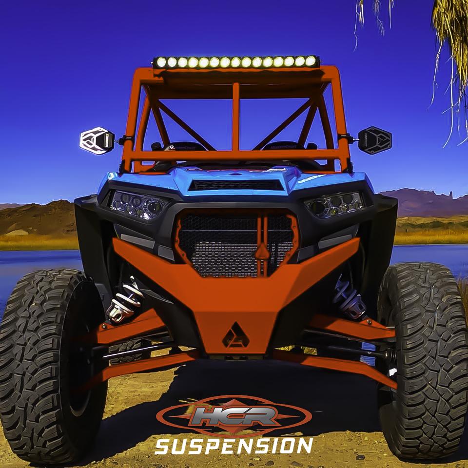 HCR Racing RZR-05300-1 Polaris RZR XP 1000 Dual Sport Front A-arms on a UTV with rugged terrain and bright LED light bar.