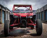HCR RACING TAL-05400 HONDA TALON 1000R LONG TRAVEL SUSPENSION KIT showcased on a UTV in a storage area.