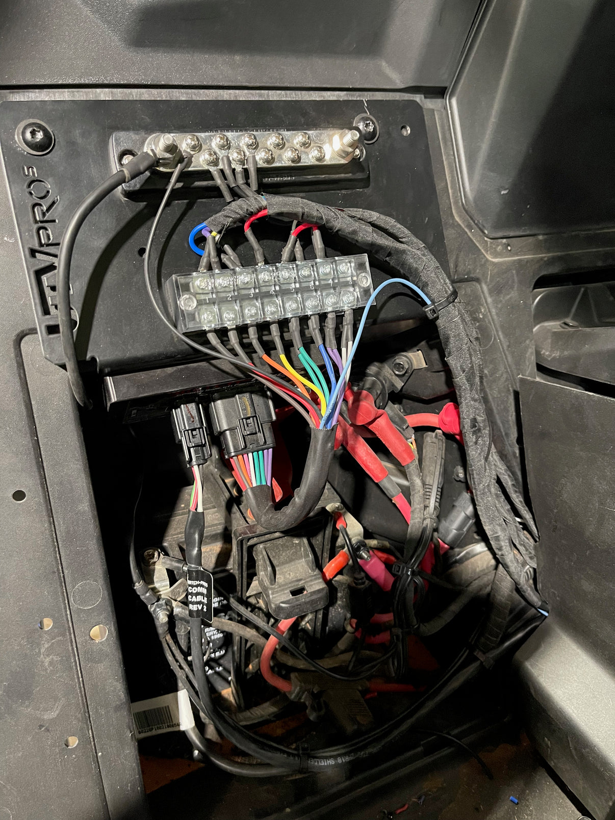 UTV Pro's CAN AM X3 SWITCH PRO MOUNT wiring harness installation inside a UTV for seamless off-road performance.