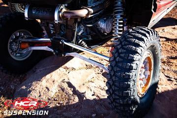 RZR-05706 RZR XP1K / RS1 Mid-Travel Aluminum High Clearance HCR Spec Rear Links on off-road vehicle tire.