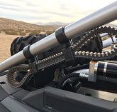 UTV SPARE BELT MOUNT BY DT RACING installed on a roll cage for spare belt storage in off-road vehicles.
