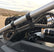 UTV SPARE BELT MOUNT BY DT RACING installed on a roll cage for spare belt storage in off-road vehicles.