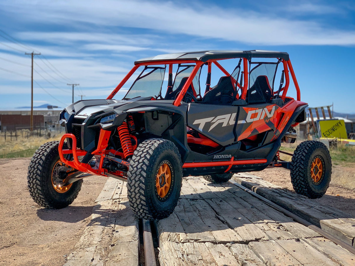 HCR RACING TAL-05500 HONDA TALON 1000X LONG TRAVEL SUSPENSION KIT showcased in off-road terrain.