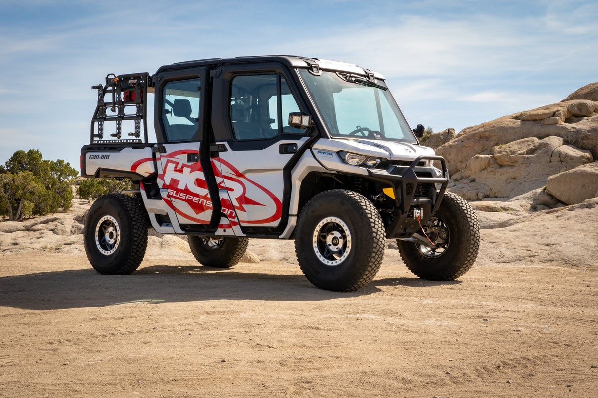 HCR CAN-AM DEFENDER FRONT FORWARD A-ARM SUSPENSION KIT showcased on a rugged side-by-side in an off-road setting.