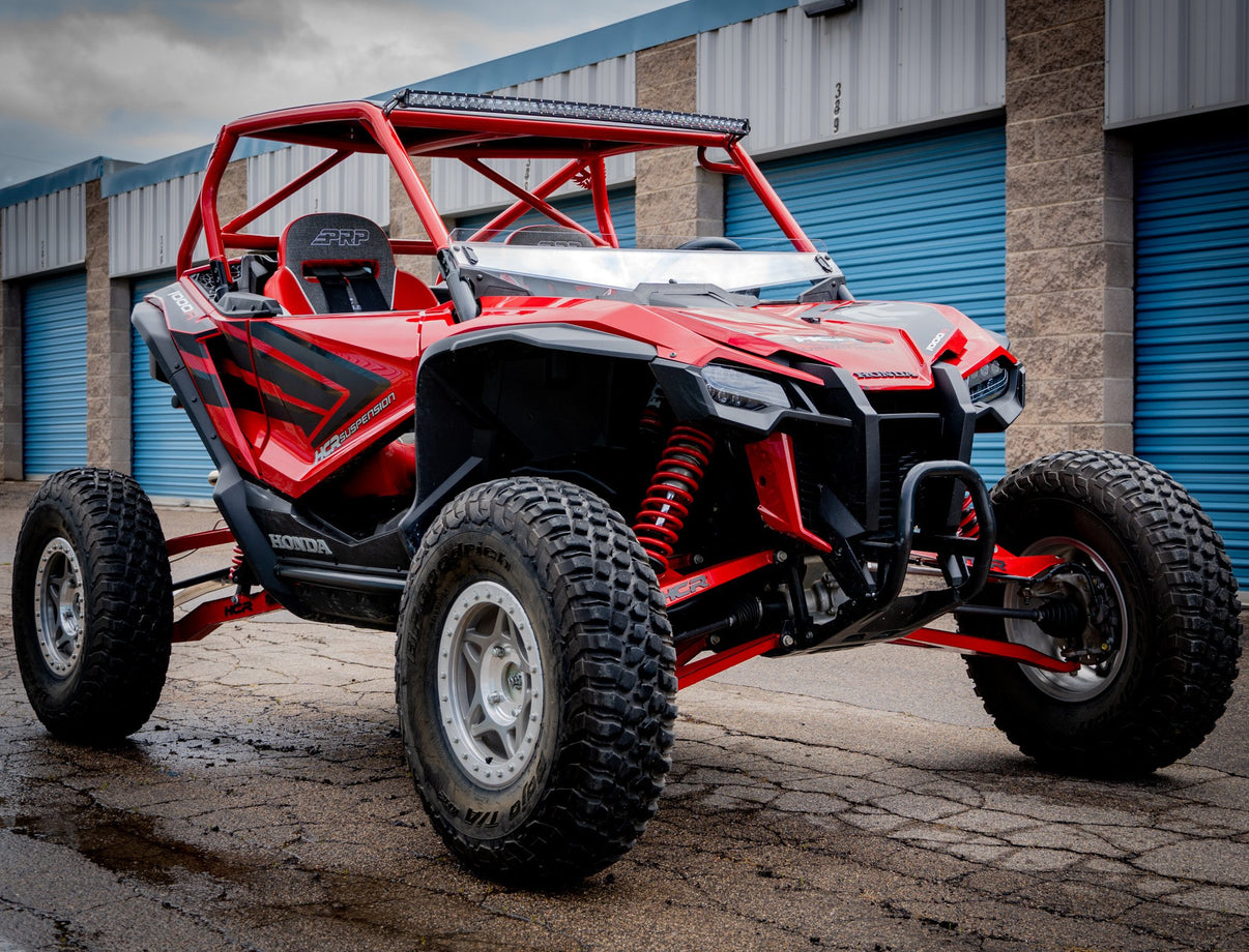 HCR RACING TAL-05400 HONDA TALON 1000R LONG TRAVEL SUSPENSION KIT on a red UTV with off-road capabilities.