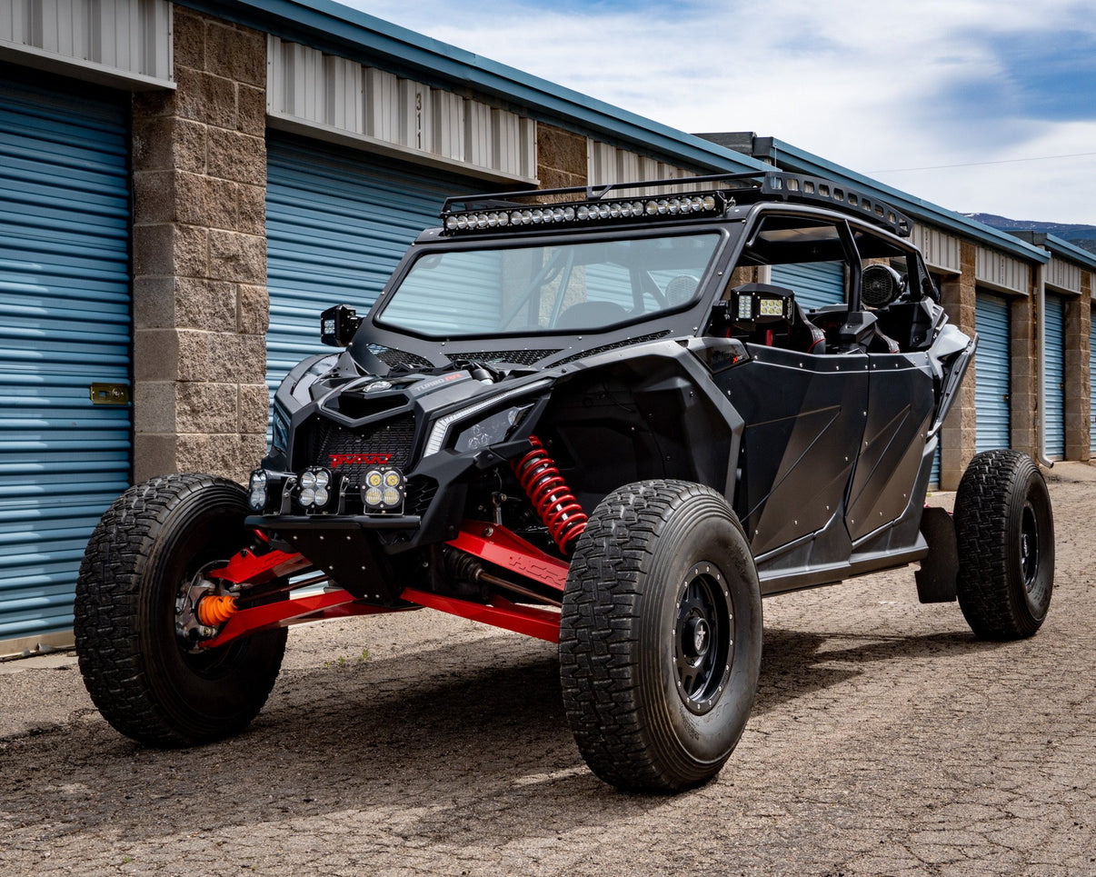 Can-Am Maverick X3 X RS 72" OEM Dual-Sport HD Factory Replacement Suspension Kit showcased in a garage.
